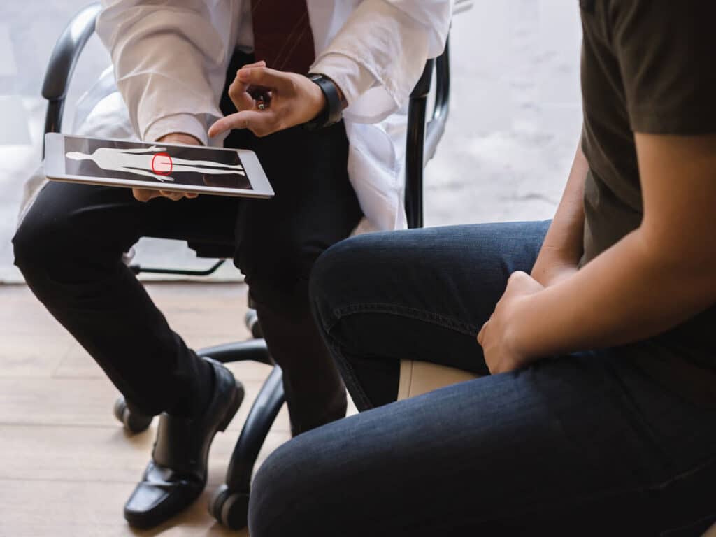 doctor showing man prostate location on image
